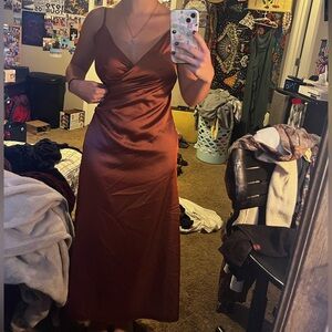 Long, brown, floor length dress.